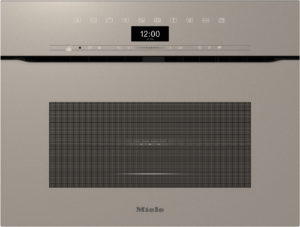 Beige Miele kitchen appliance front with a row of control icons, a centered digital clock reading 12:00, and a large vent grille below.