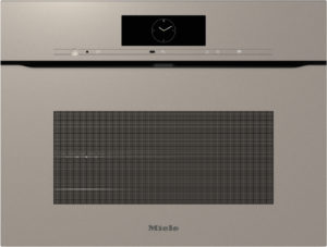 Built-in Miele oven front with a circular clock display, slim control bar, and a large vented viewing window above the logo.