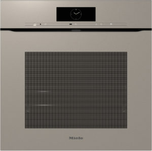 Built-in beige oven front with a centered digital clock display and minimalist control strip above a large vented panel (Miele).