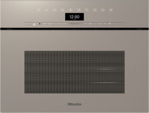 Miele built-in oven front in bronze with a central clock reading 12:00, control icons above, and a large perforated vent area below the clock.