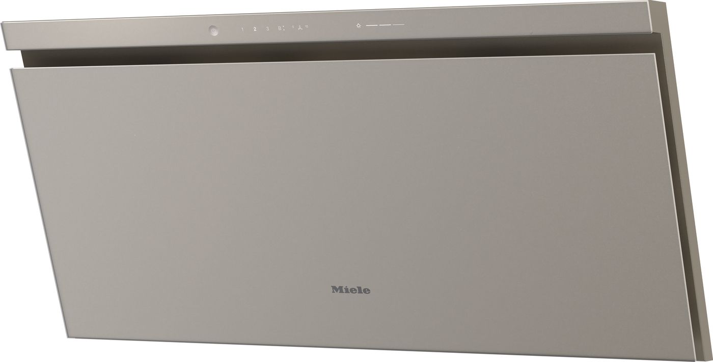 Beige Miele wall-mounted range hood with a slim front panel and touch controls along the top edge.