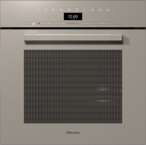 Beige Miele built-in oven with a long metallic handle, a large glass door window, and a digital clock reading 12:00 at the top; brand name Miele at the bottom.