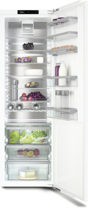 Open refrigerator with stainless interior and glass shelves, showing berries, grapes, eggs, milk, juice, cheese, greens in crispers, and door shelves.