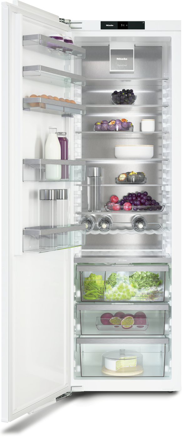 Open white refrigerator with organized shelves holding eggs, berries, grapes, vegetables, dairy, juice, and cheese.
