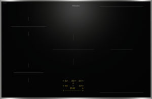Miele induction cooktop: black glass surface with slim silver trim, subtle control lines, and orange digital timer/display at the bottom center.