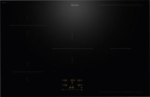 Black glass induction cooktop with subtle glow; digital control panel in yellow at the bottom center (Miele).