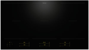 Miele black glass induction cooktop with touch controls and yellow digital readouts at the front edge.