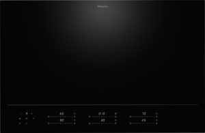 Black Miele induction cooktop with a sleek black glass surface and a glowing control strip along the bottom showing heat settings and timers