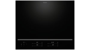 Miele black induction cooktop with a glowing horizontal control line along the bottom edge and touch controls.
