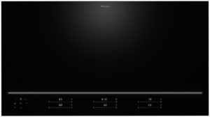 Miele black glass induction cooktop with a thin glowing control strip along the bottom edge.