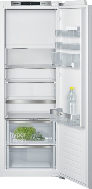 Open Siemens refrigerator showing empty shelves and door racks; bottom crisper contains lettuce/greens.