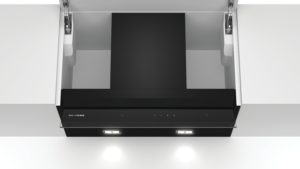 Angled view of a sleek black Siemens range hood with two LED lights, installed under a white ceiling cabinet.