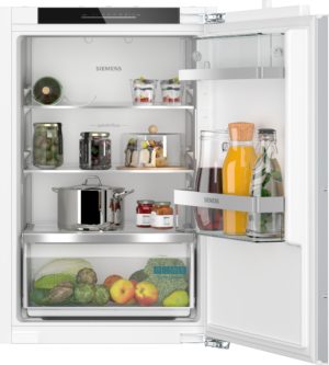 Open Siemens refrigerator showing jars, bottles, and fresh fruit on shelves and in door compartments.