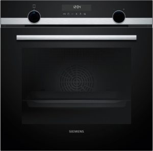 Close-up of a black Siemens oven front with a silver horizontal handle and circular knobs on either side.