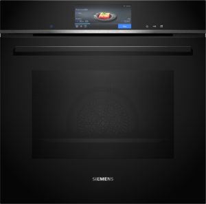 Siemens kitchen appliance with a central touchscreen displaying a fruit crumble dish on the screen.