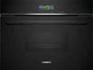 Close-up of a sleek black Siemens appliance with a small display showing 'Green beans' and meal info, branding visible at bottom