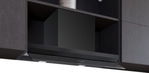 Modern black range hood installed under dark wood cabinets above a stove, with built-in lighting and Siemens logo on the control panel underneath.