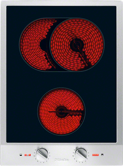 Electric stovetop with glowing red coil burners: two at the top and one at the bottom, with control knobs beneath.