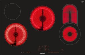 Black kitchen appliance control panel showing red glowing circular induction burners with Siemens logo at bottom center