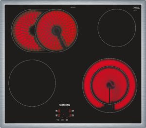 Induction cooktop with two active circular zones glowing red and Siemens branding, digital controls below.