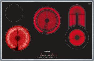 Black Siemens glass-ceramic electric cooktop with multiple red-hot burners and a central control area at the bottom edge.