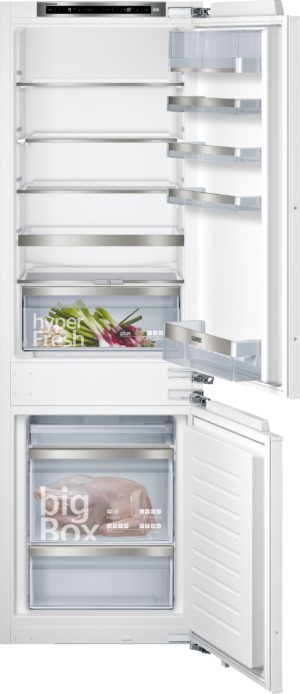 Open white refrigerator showing multiple metal shelves, right-side door racks, and a bottom freezer drawer; Siemens branding on the handle area.