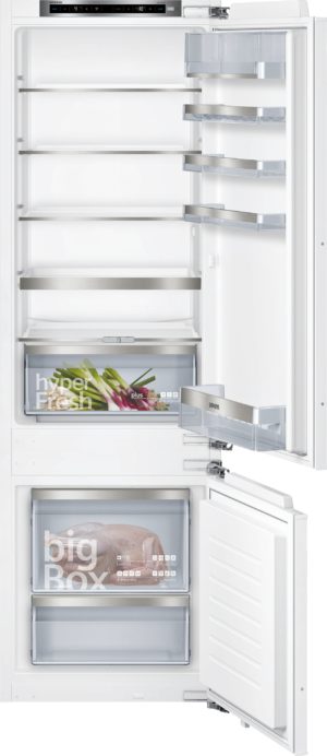 Full-height view of an open Siemens refrigerator with multiple shelves, a bottom freezer, and transparent drawers showing food storage graphics like 'hyperFresh' and 'big Box'