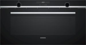 Close-up of a black Siemens oven control panel with a digital clock reading 12:04, large silver handle, and round control knobs on each side.