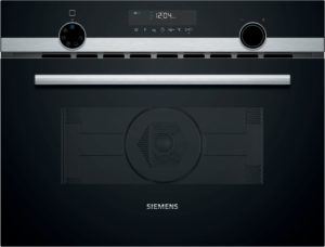 Top control panel of a Siemens oven with two large dials and a brushed metal strip, set against a dark background.