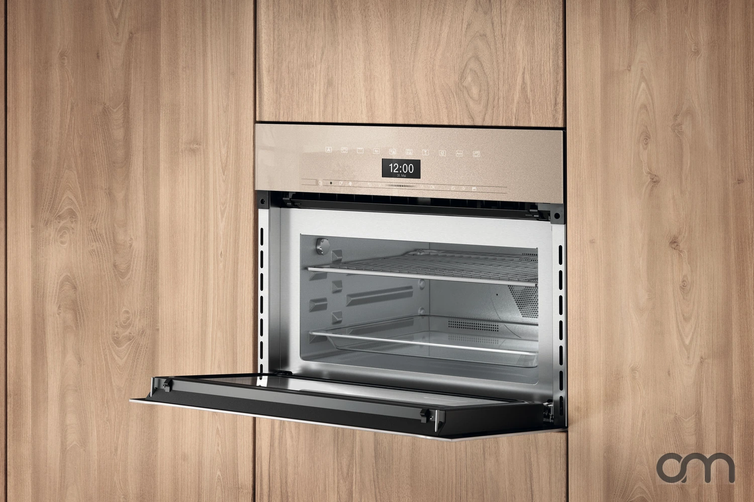 Four compact vapeur Miele encastré dans une façade en bois, porte abattante ouverte sur une cavité inox parfaitement propre