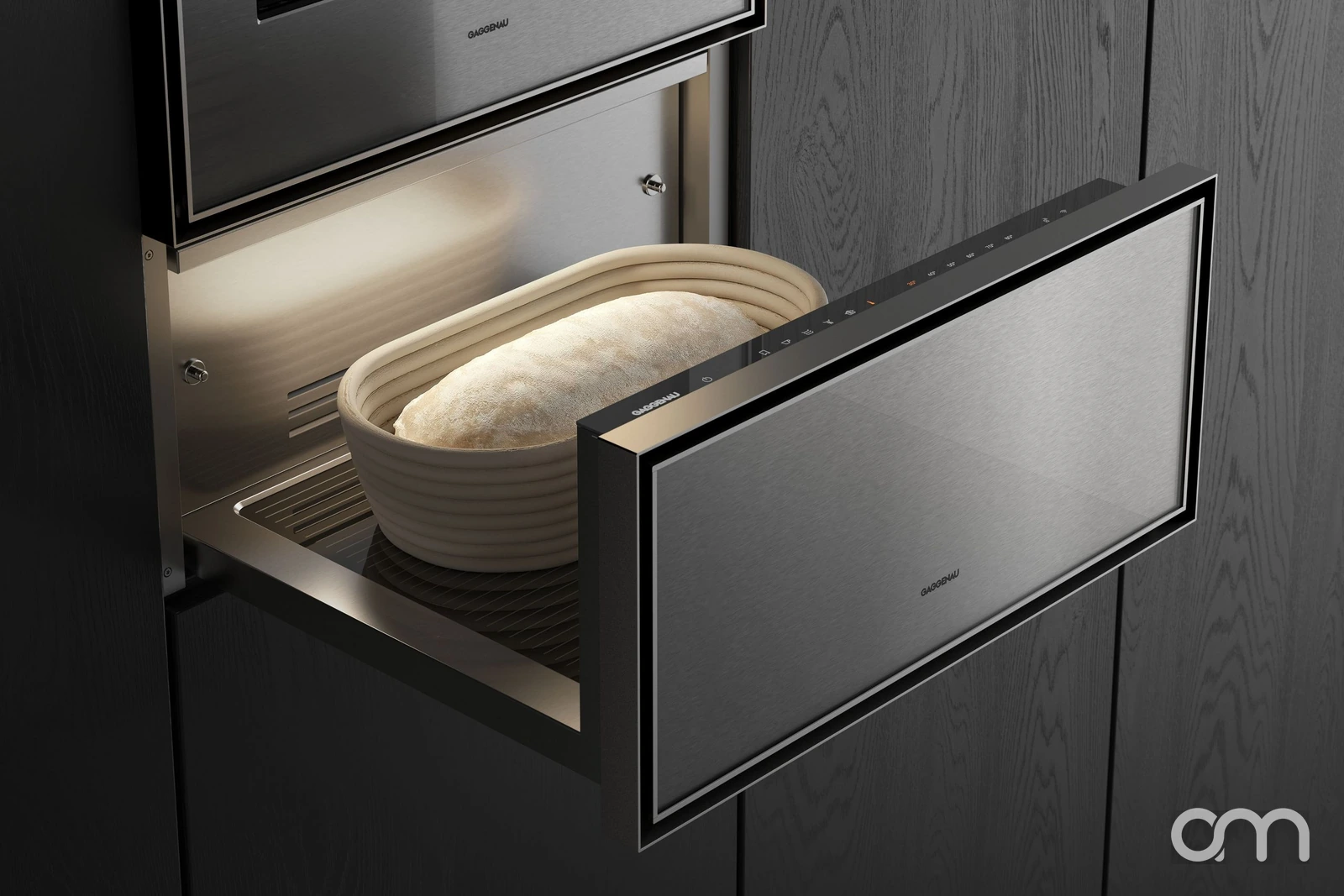 Tiroir chauffant culinaire Gaggenau Expressive ouvert, pâte à pain en banneton en cours de levée sous le four encastré — appareils disponibles chez Arts & Ménagers, canton de Neuchâtel